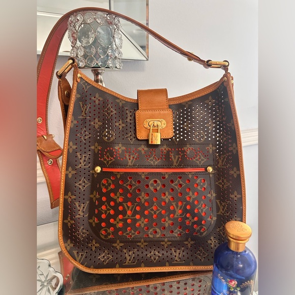 LOUIS VUITTON
Limited Edition orange Monogram Perforated Musette
Bag! Preloved - Picture 1 of 12